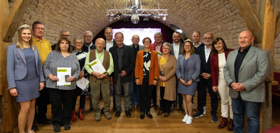 Eine Gruppe von Menschen steht im Maikammerer Rassiga-Keller. 