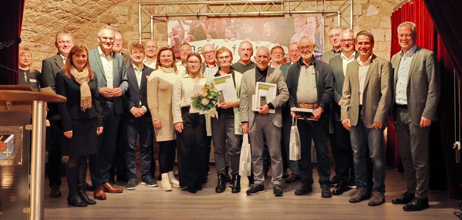 Gruppenfoto der Geehrten und Gratulanten bei der Ehrung der Ehrenamtlichen im Sport 2025 im Bürgerhaus in Maikammer.