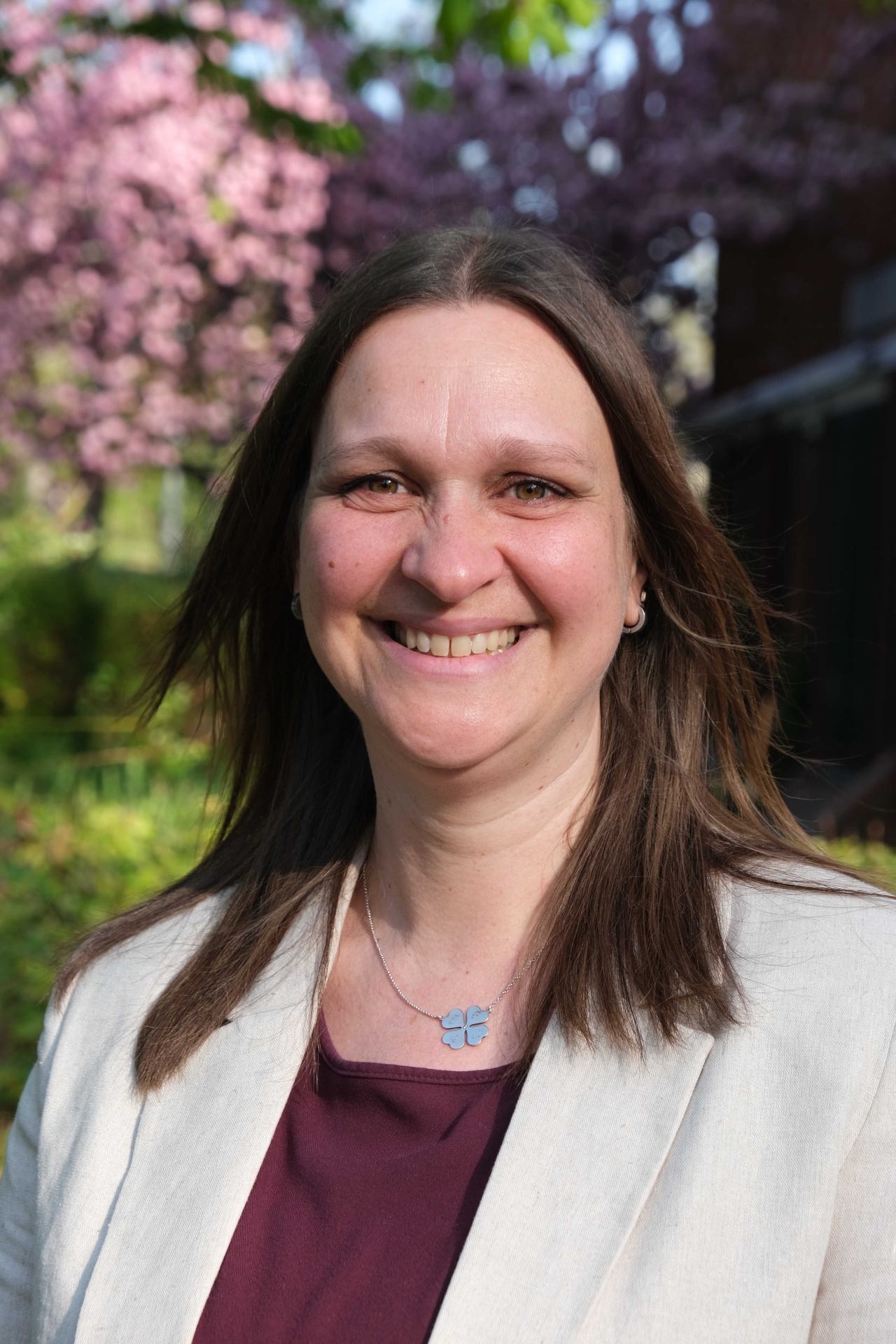 Frau vor blühenden Bäumen.