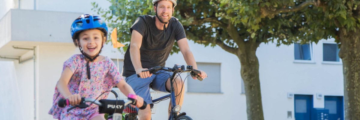 Ein Mann und ein junges Mädchen fahren Fahrrad.